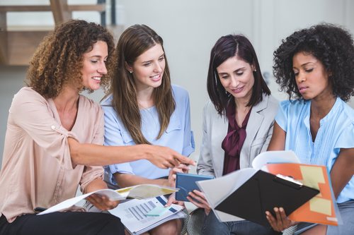 A grup of women discuss processes 