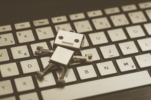 A cartoon chatbot on a computer keyboard