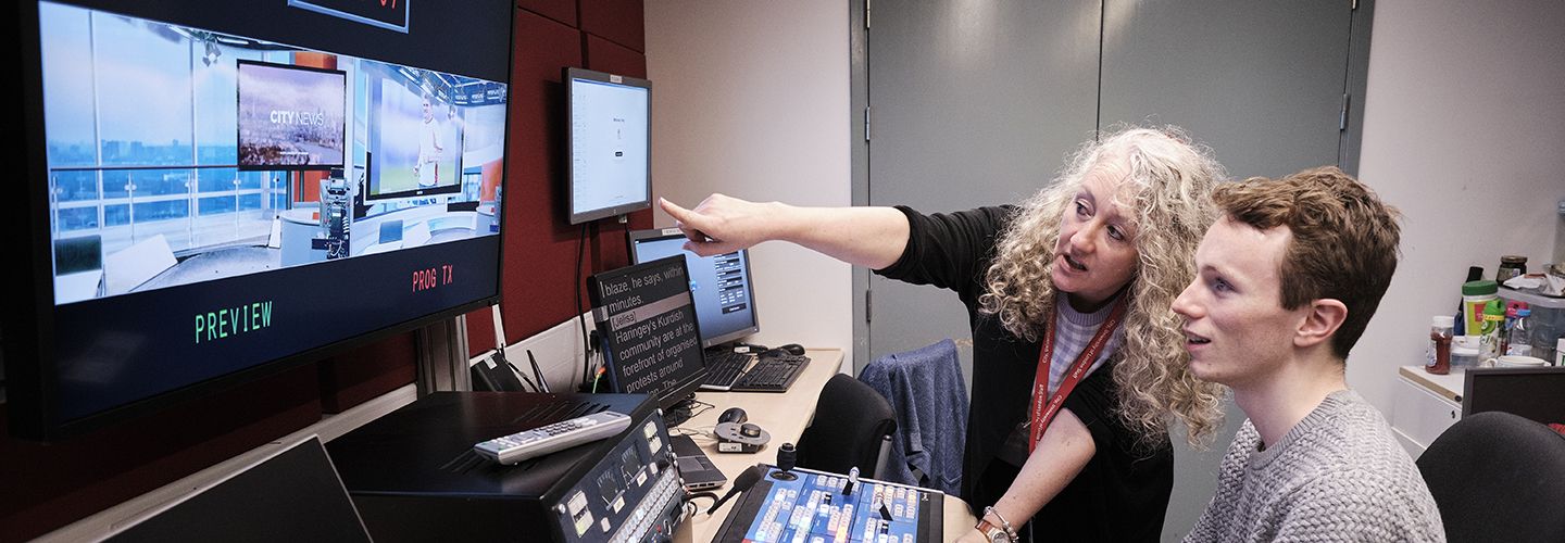 Student using media facilities with a tutor at City, University of London