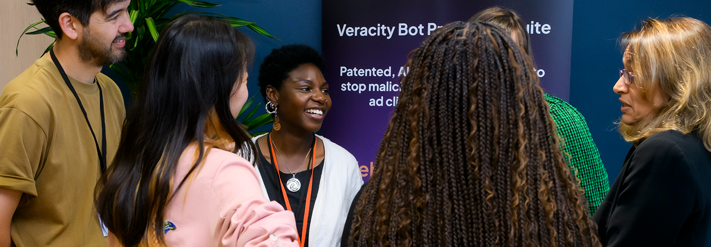 A group of people network at the CityVentures event, they are smiling