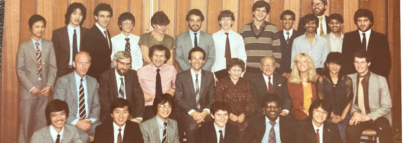 A group of students and academics in a formal group photo in three rows