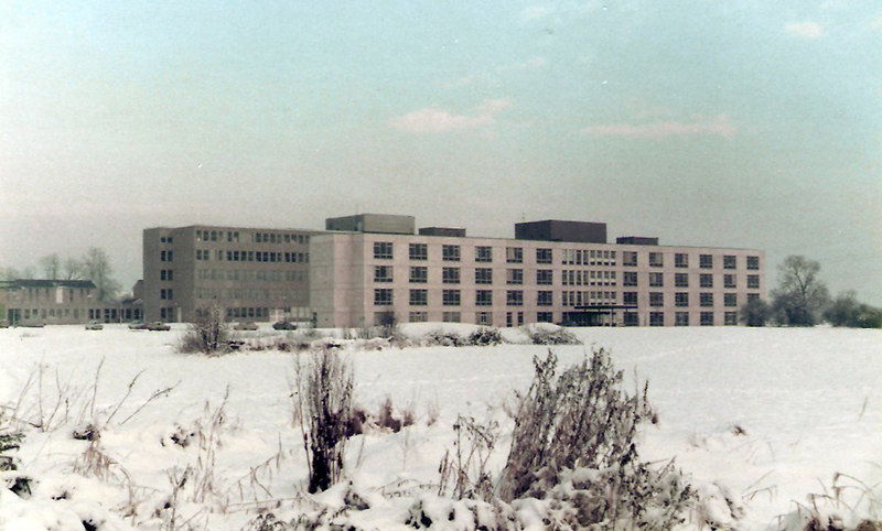 Run down old buildings sit in snowy ground