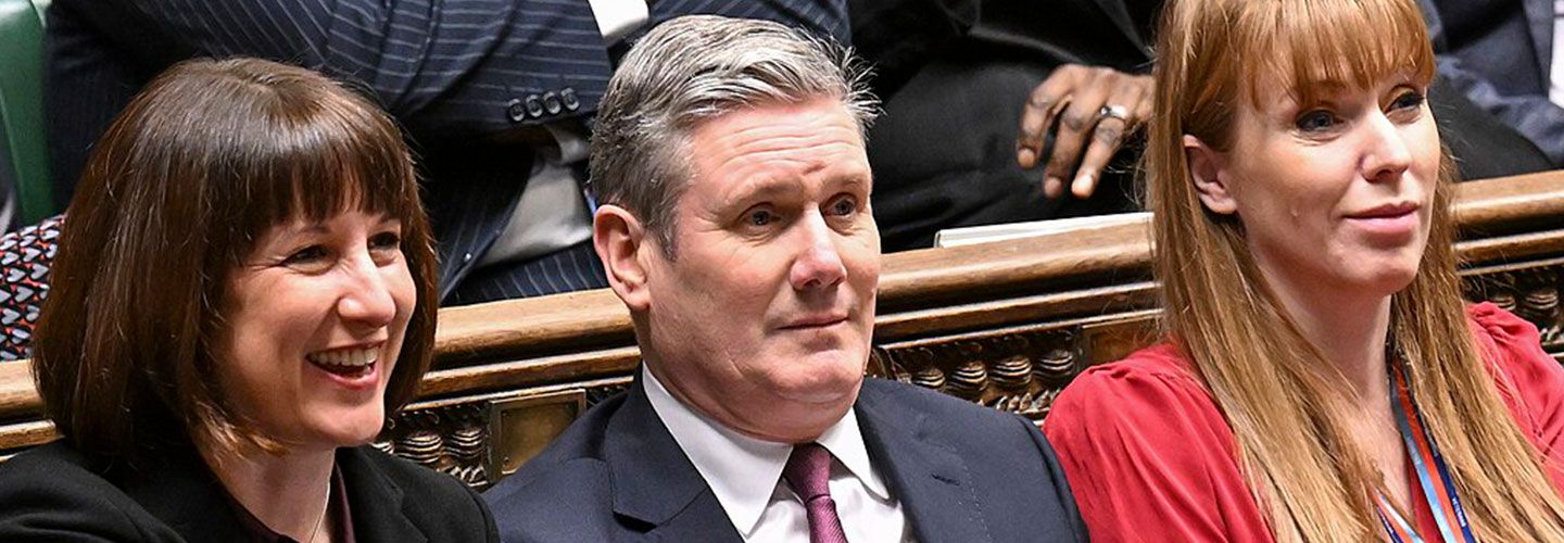 Chancellor Rachel Reeves, Prime Minister (PM) Sir Keir Starmer and Deputy PM Angela Rayner sit at the front benches in Parliament.