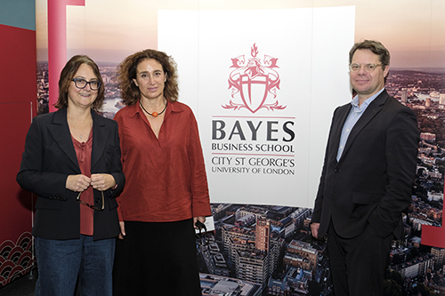 Giacinta Cestone, Barbara Petrongolo and Andre Spicer standing in front of a Bayes Business School banner.