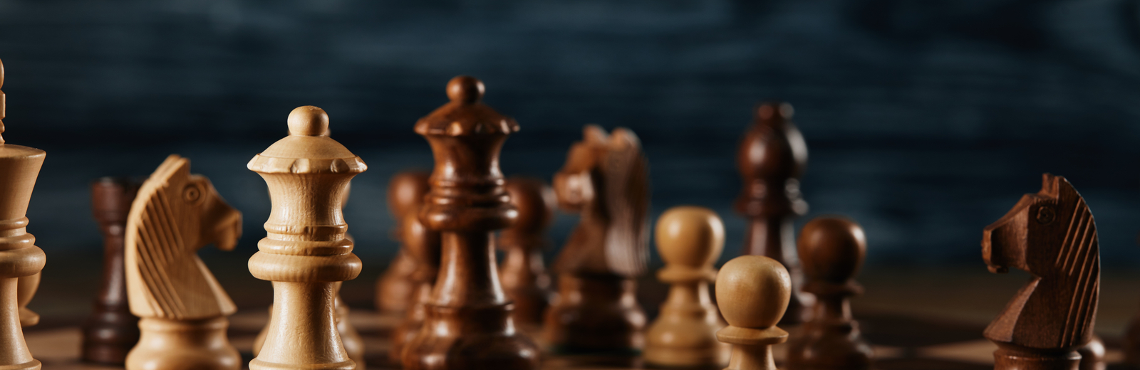 Chess pieces on a wooden chess board