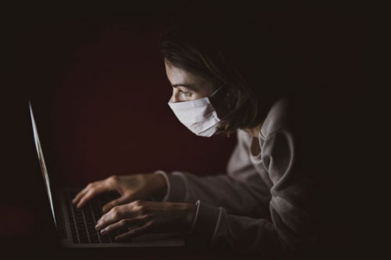 Stock photo of a reporter in a face mask