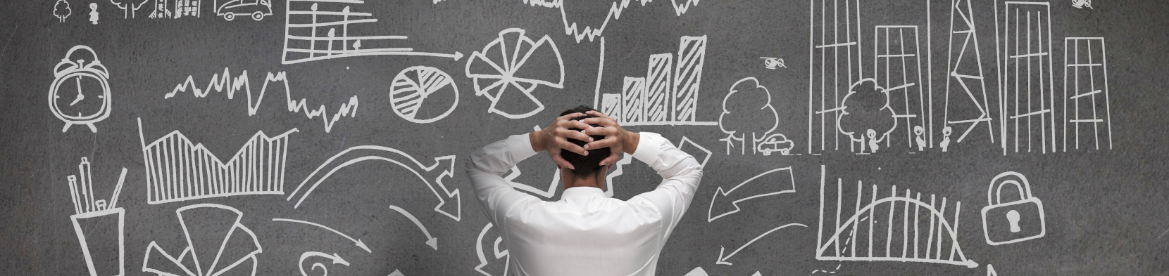 A confused man looks at a blackboard