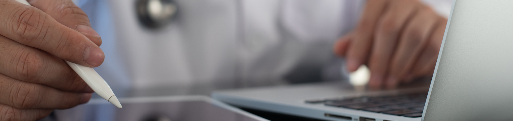 A doctor looks at a digital device
