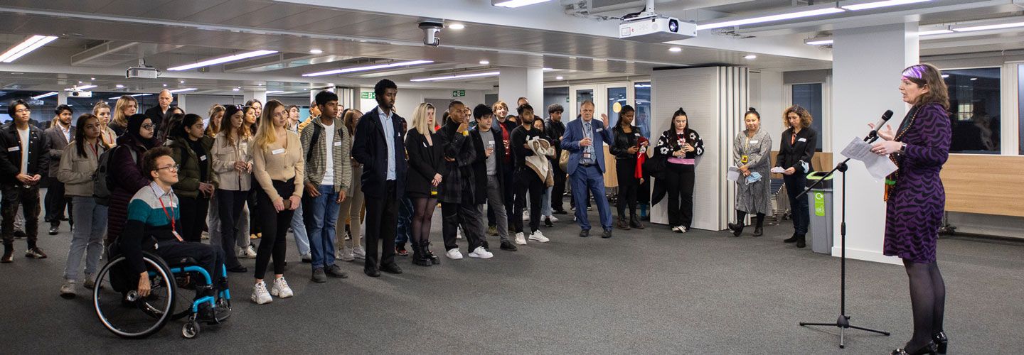 Dr Sionade Robinson addresses the students banner
