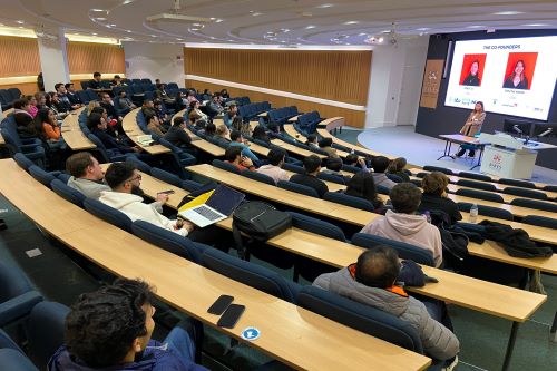 A group of students listen to entrepreneur Joey Li