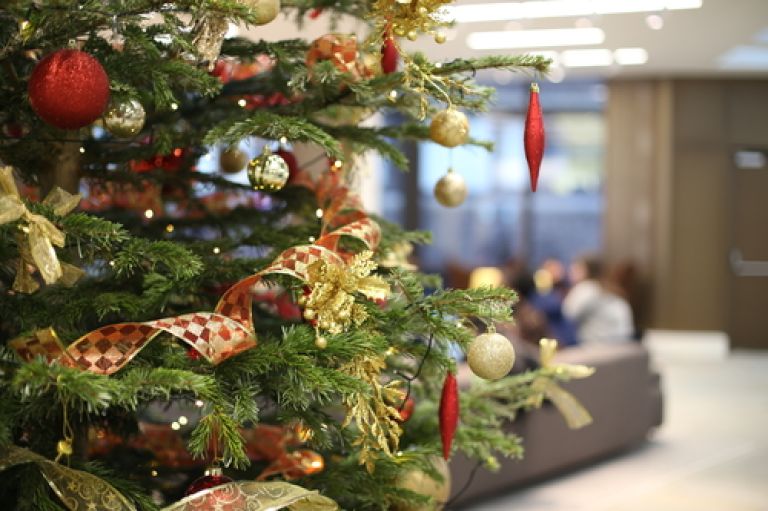 A close-up shot of a Christmas tree decorated with lights