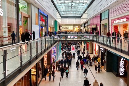 people walking through a crowded shopping centre