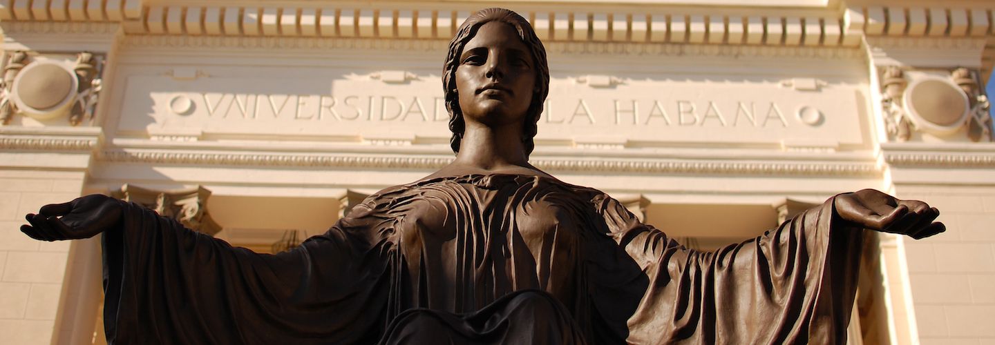 A statue of a woman with arms outspread in front of Havana University