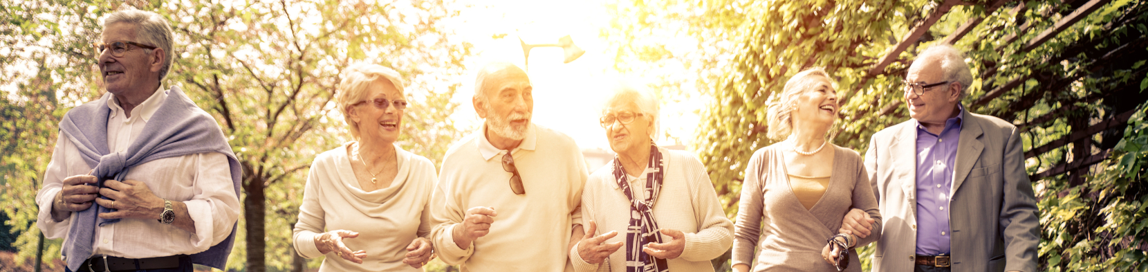 A group of elderly people smile together