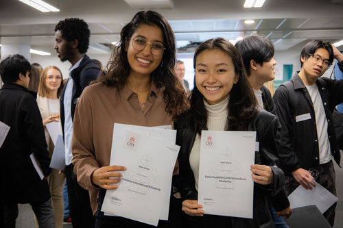 Two students, Noam Achrak and Yuxin-Teng-Jin pose with their certificates. 
