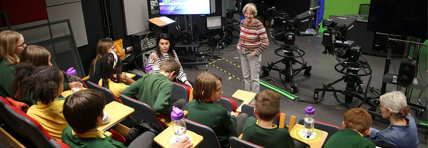 St John's Vale Church of England primary school children with Professor Emeritus Lis Howell at City's Journalism Department TV studio