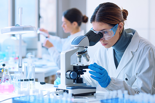 Pharmacist researcher using a microscope