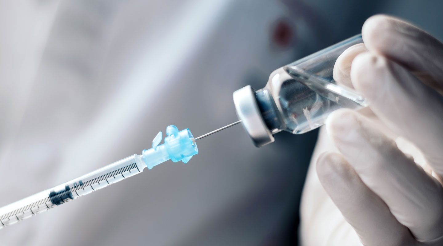 injecting injection vaccine vaccination medicine into a syringe woman nurse