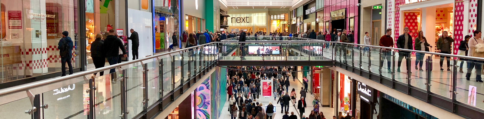 people walking around a crowded shopping centre