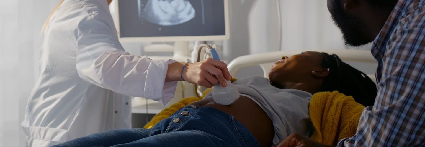 Mother having an ultrasound scan with father present