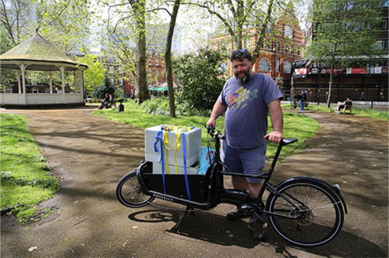 City's beekeeper, Barnaby Shaw from Bee Urban, transports a new colony of bees on a bike through Northampton Square