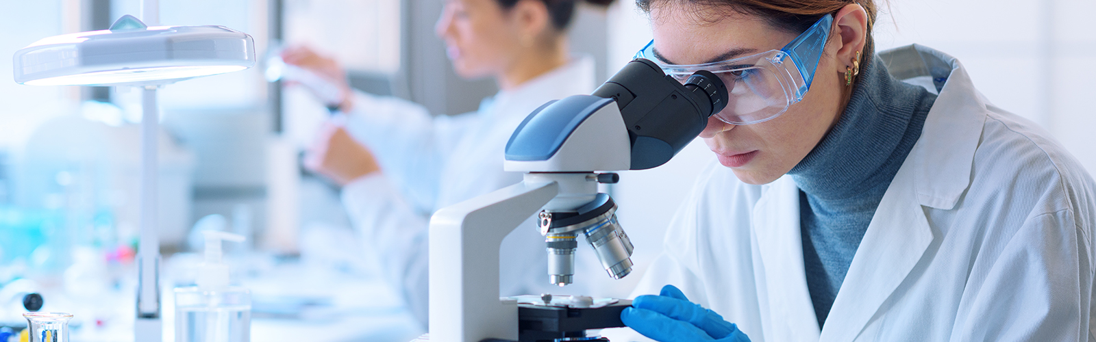 Pharmacist researcher using a microscope