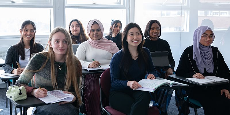 Students sat in chairs in teacher room