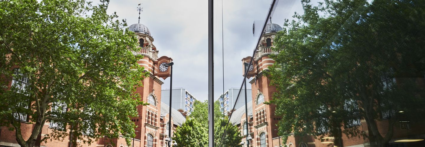 College Building reflected on the windows of Rhind Building