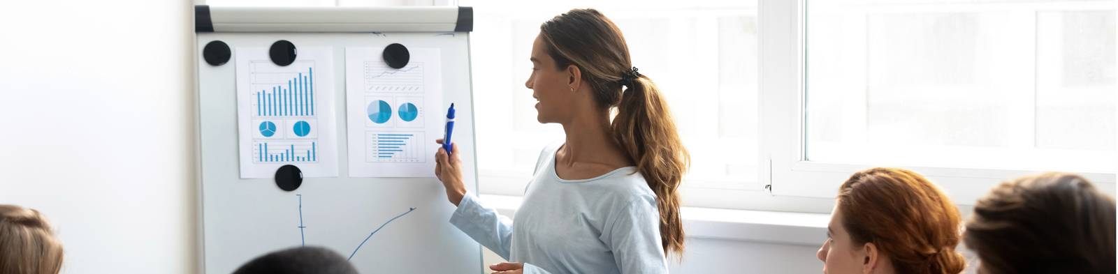 Woman presenting to colleagues in the boardroom