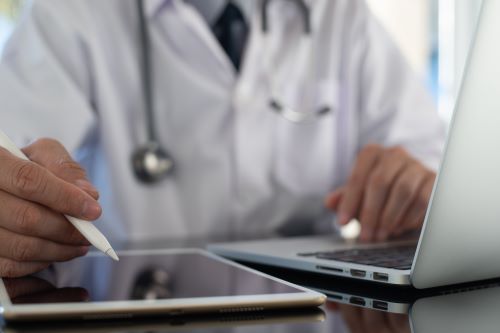 A doctor peruses a digital device