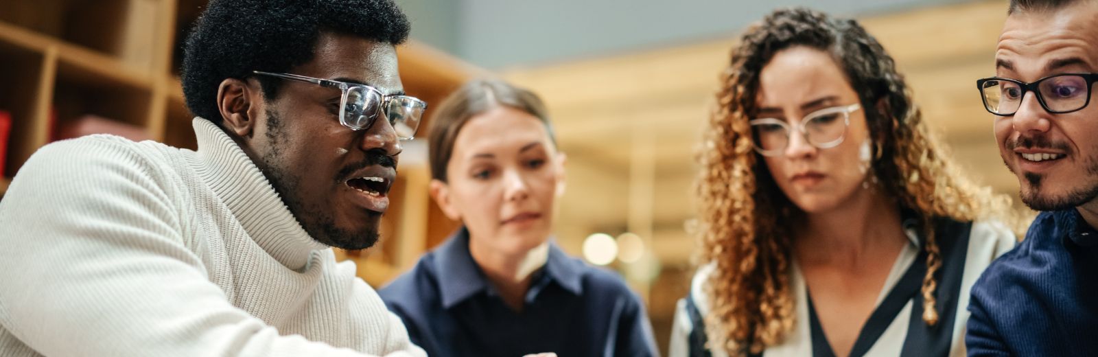 Multiethnic young group of people brainstorming together in a meeting room at the office