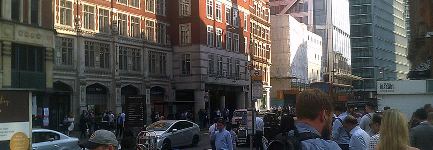 People walking along Bishopsgate with shops and offices in view