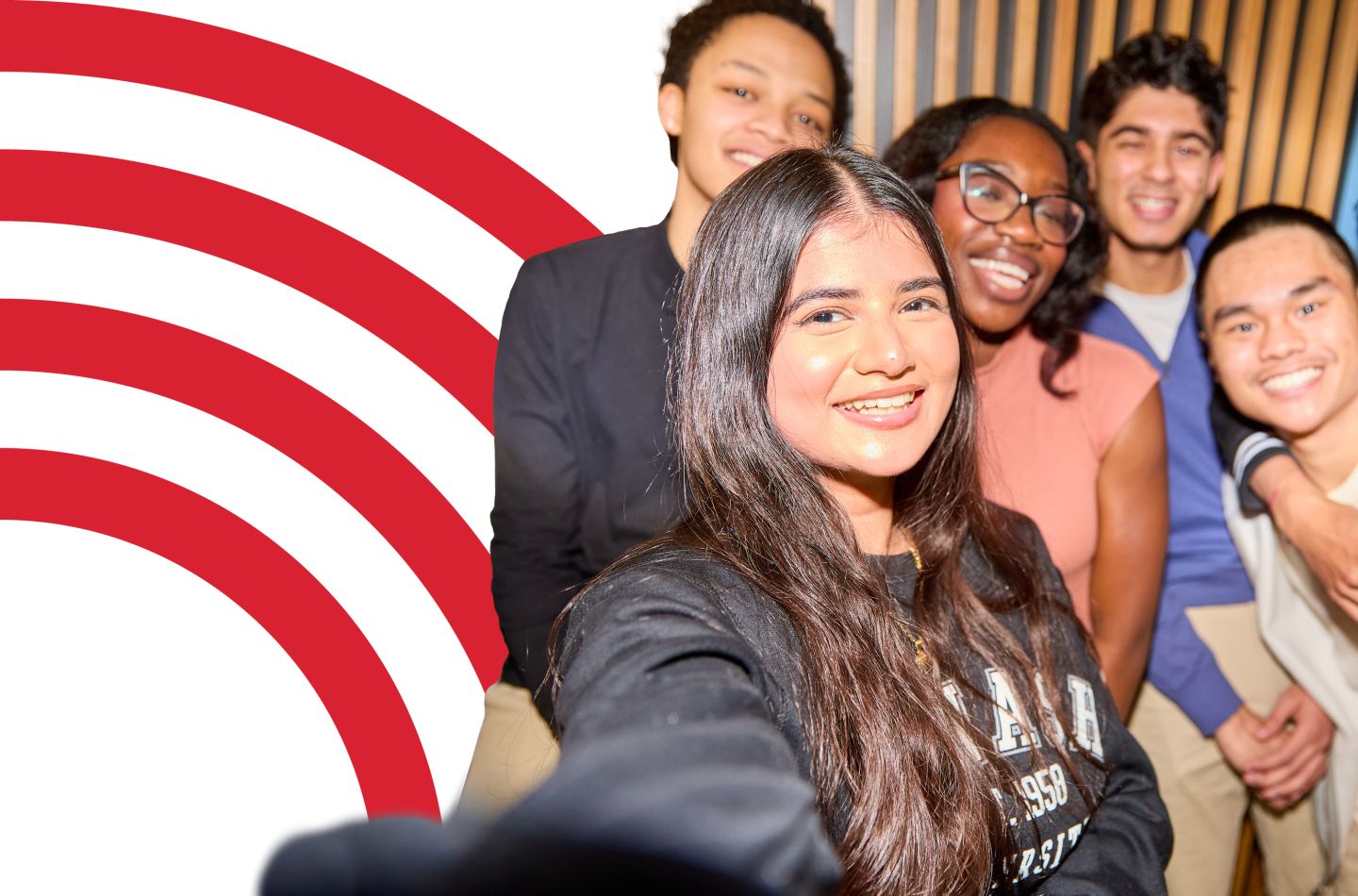 Group of smiling students taking a selfie.