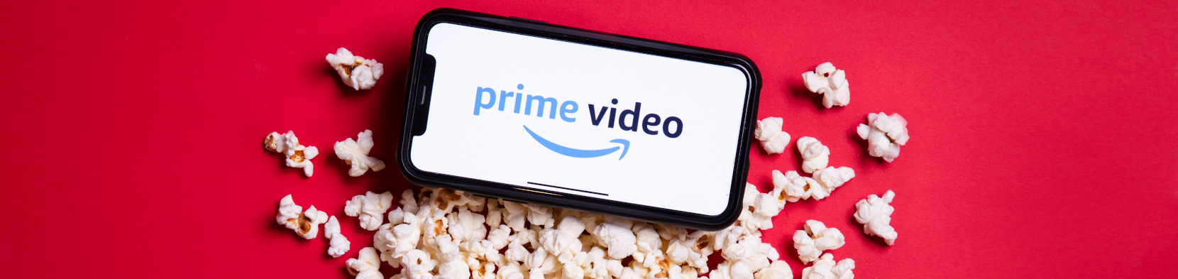 A mobile phone atop some popcorn