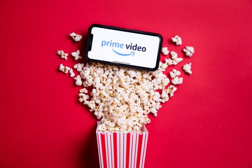 A mobile phone atop some popcorn