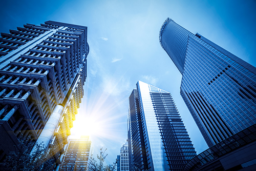 view of buildings from the ground upwards with sun shining