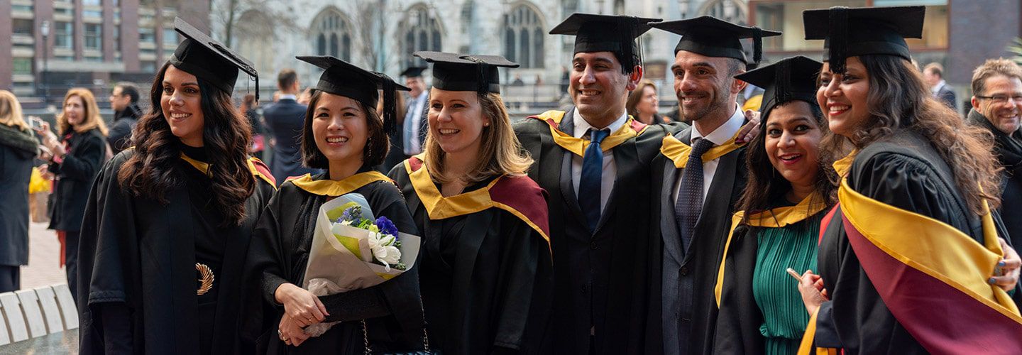 City graduates standing together wearing mortarboards