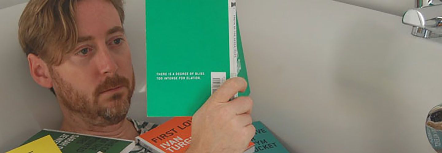 Jonathan Gibbs read poetry books in the bath while surrounded by other books.