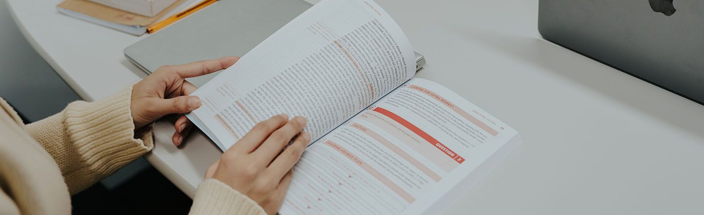 City law school student reading from a textbook in the library