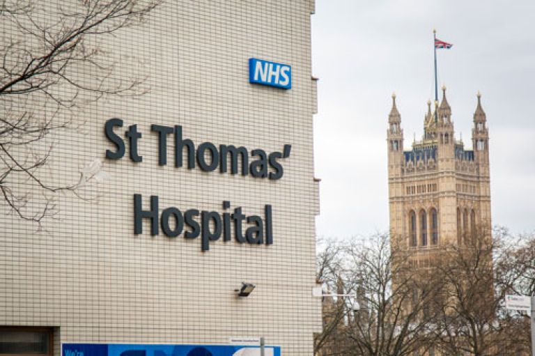St Thomas’ Hospital sign with the Houses of Parliament in the background.