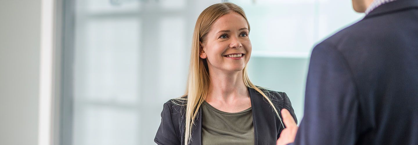 A female student faces a male student in conversation.