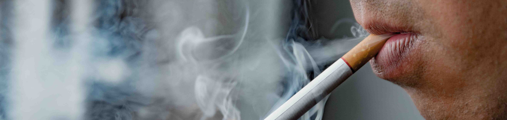 A smoker takes a drag on a cigarette