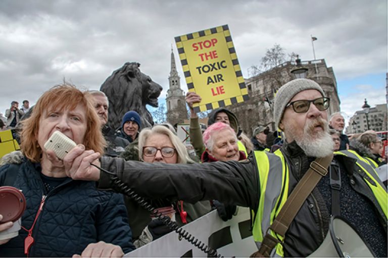 Ulez protesters with a placard megaphone
