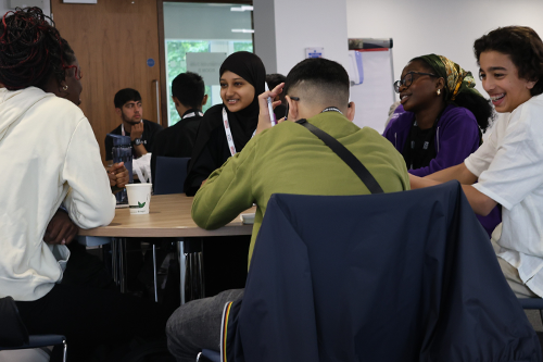 A group of pupils and a student ambassador chat to each other