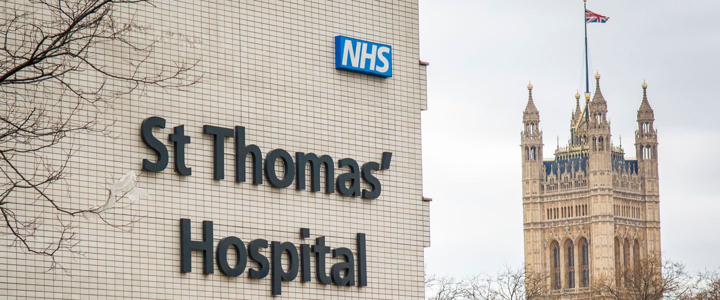 St Thomas’ Hospital sign with the Houses of Parliament in the background.