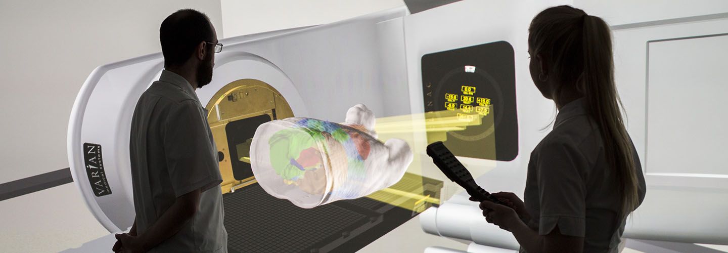 Two radiography students operate the screen to look at virtual cross sections of patients and their CT scans.