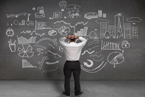 A confused man looks at a blackboard