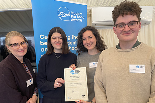 Sally Giill holding certificate with students